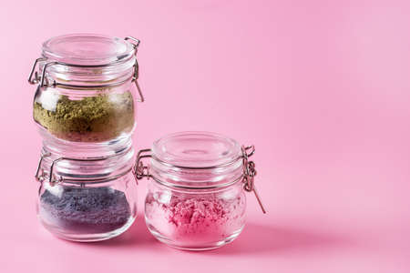 Different of japanese matcha tea green red and blue in glass jars on Pink Background Acai Berry Powder green tea leaf powder clitoria flower powder copy spaceの写真素材