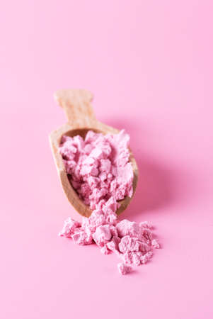 Small Wooden Scoop with Red or Pink Matcha Powder Pink Background Copy Spaceの写真素材