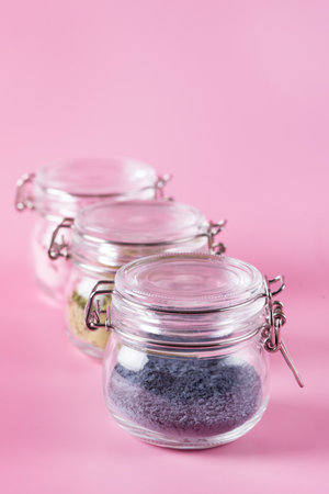 Different of japanese matcha tea green red and blue in glass jars on Pink Background Acai Berry Powder green tea leaf powder clitoria flower powder Verticalの写真素材