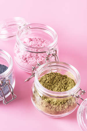 Different of japanese matcha tea green red and blue in glass jars on Pink Background Acai Berry Powder green tea leaf powder clitoria flower powder verticalの写真素材