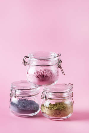 Different of japanese matcha tea green red and blue in glass jars on Pink Background Acai Berry Powder green tea leaf powder clitoria flower powder verticalの写真素材