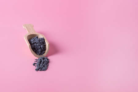 Small Wooden Scoop with Blue Matcha Powder Pink Background Copy Spaceの写真素材