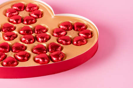Beautiful Red Chocolate Hearts Candies in Red Box Shape of Heart on Pink Background St Valentine Day Background Dessert Horizontalの写真素材