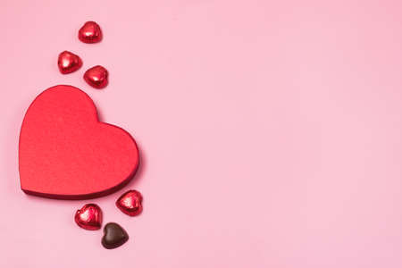 Beautiful Red Chocolate Hearts Candies in Red Box Shape of Heart on Pink Background St Valentine Day Background Dessertの写真素材