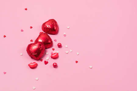 Beautiful Red Chocolate Hearts Candies on Pink Background Valentine Day Holiday Background Copy Spaceの写真素材