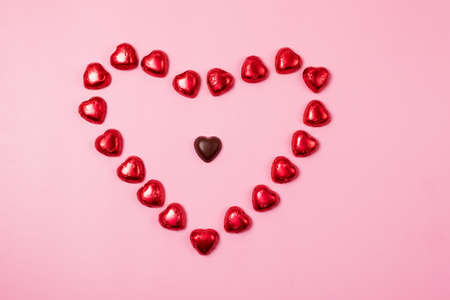 Beautiful Red Chocolate Hearts Candies on Pink Background Valentine Day Holiday Backgroundの写真素材