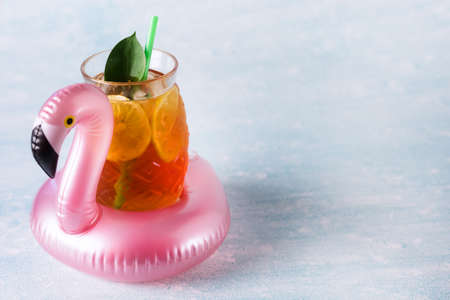 Summer Beach composition Inflatable Mini flamingo with Cold Drink on Pastel blue background Pool Float Party Trendy Concept Flat lay Horizontalの写真素材