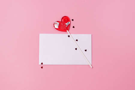 Mock up Valentines day concept Red lollipop heart shape and White Blanck on a pink background...