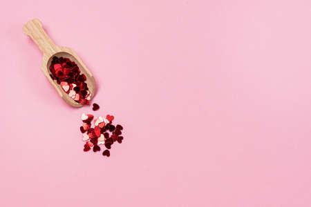 Bright Heart Shaped Confetti and Scoop on Pink Background Top View Horizontal Copy Spaceの写真素材
