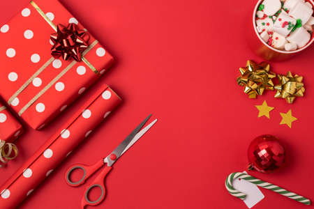 Christmas background Christmas present box cup of chocolate with marshmallow and decorations on red background Top view with copy space Horizontalの写真素材
