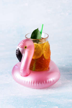Summer Beach composition Inflatable Mini flamingo with Cold Drink on Pastel blue background Pool Float Party Trendy Concept Vericalの写真素材