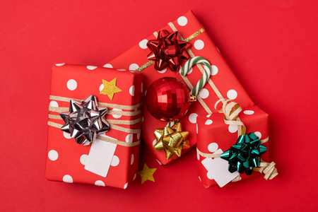 Three Gift Boxes for Christmas Holidays on Red Background Confetti Festive Background Horizontal