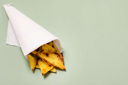 Homemade Chips Tortilla or Nachos on Green Background Top View Horizontal Copy Spaceの写真素材