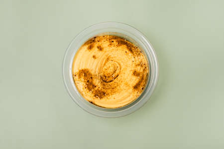 Bowl of Healthy Homemade Hummus on Green Background Top View Horizontal Healthy Vegan Food Horizontalの写真素材
