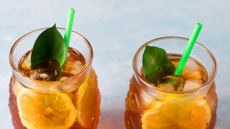 Traditional Iced Tea with Lemon and Ice in Glasses in Shape of Pineapple Horizontalの写真素材
