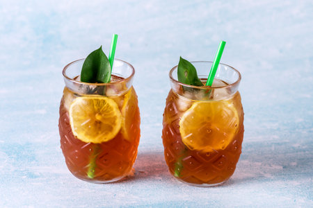 Traditional Iced Tea with Lemon and Ice in Glasses in Shape of Pineapple Horizontalの写真素材