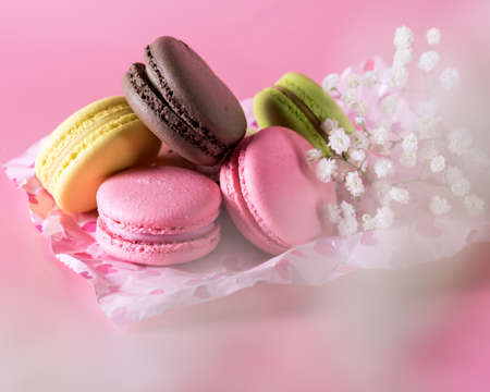 Colored Macarons Modern French Delicate Dessert Lemon Pistachio Strawberry Vanilla Macarons White Flowers Horizontalの写真素材