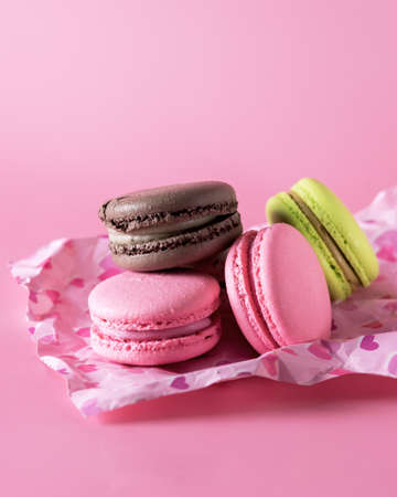 Sweet Colorful Macarons on Pink Background Tasty Colorful Macaroons French Dessert Verticalの写真素材