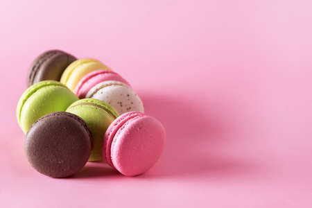 Sweet Colorful Macarons on Pink Background Tasty Colorful Macaroons French Dessert Copy Spaceの写真素材