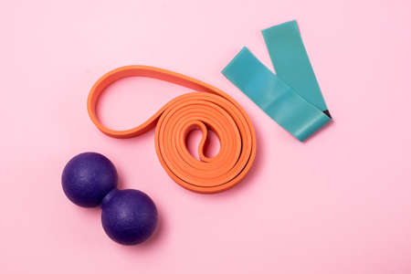 Fitness Bands and Rollers for Yoga Pilates or MFR Minimal Home Fitness Concept Top View Pink Backgroundの写真素材