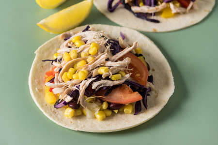 Tacos with Vegetables and Corn and Chicken on Green Background Horizontalの写真素材
