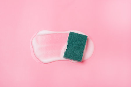 Cleaning Sponge and a Soapy Foam on a Pink Background Cleaning Concept Cleaning Service Banner Flat lay Top viewの写真素材