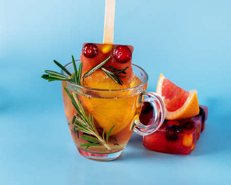 Healthy Summer Dessert Frozen Berry and Citrus Tea ice with Rosemary in Glass Tea Cup Horizontalの写真素材