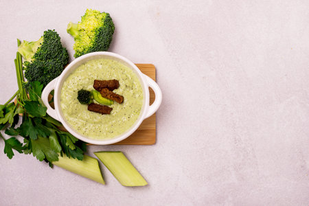Green Vegetable Cream Soup in a White Bowl on a Gray Concrete Background Top View Vegan Soup Puree of Green Vegetables Vegetarian and Diet Foodの写真素材
