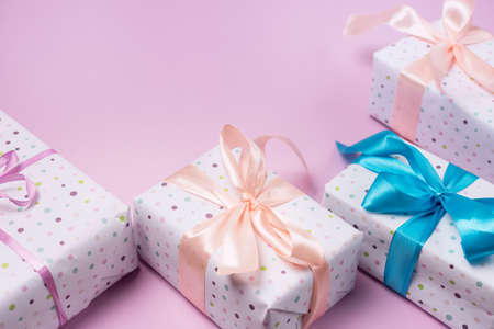 Holiday Gift Boxes on Pink Background Holiday Greeting Card Horizontal Frame Copy Spaceの写真素材