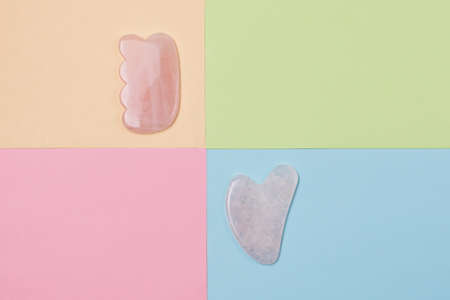 Rose Quartz Gua Sha Tool on Colorful Background Top View Horizontal Face Careの写真素材