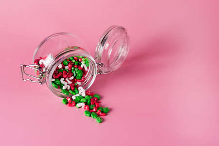 Colorful Sprinkles Jar with Sprinkles on Pink Background Confectionery Decor Horizontal Copy Spaceの写真素材