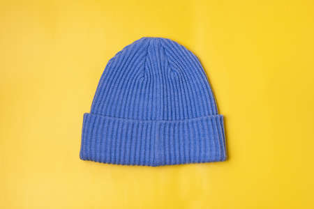 Blue Woolen Hat on Yellow Background Horizontalの写真素材