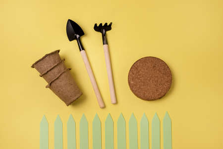 Gardening at Home Tools Rake Shovels for Seedlings Growing Vegetables and Herbs at Home Flat lay on Yellow Backgroundの写真素材