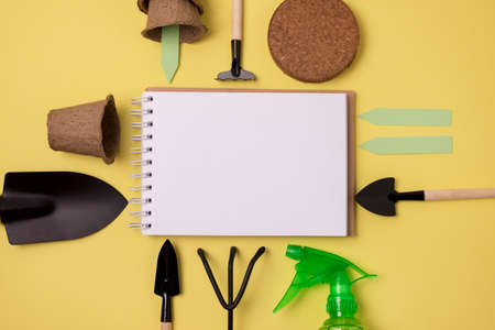 Spring Gardening Tools on Green Background Pots Gloves Coco Substrate Spade Rake Copy Space Mock Up Horizontalの写真素材