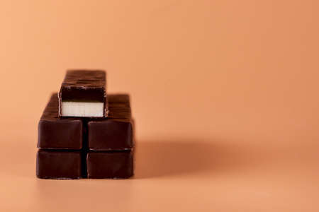 Pile of Chocolate Candy on Yellow Background Tasty Dessert Copy Space Horizontalの写真素材