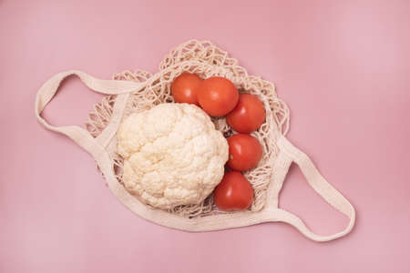 Eco Bag with Vegetable on Pink Background Cauliflower and Tomato Horizontalの写真素材