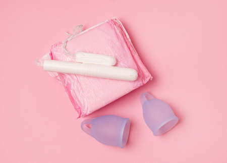 Different Types of Feminine Menstrual Hygiene Materials Products Such as Pads Cloths Tampons and Cups Top View Pink Backgroundの写真素材