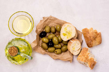 Italian Ciabatta Bread with Olive Oil and Raw Olive Light Gray Background Flat Layの写真素材