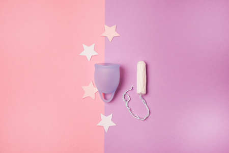 Choices Menstrual Cup or Tampon Feminine Hygiene Tampon and Menstrual Cup on a Pink and Purple Background Feminine Hygiene Productsの写真素材