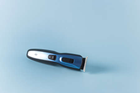 Modern Battery Electric Shaver for Man on Blue Background Horizontal Copy Spaceの写真素材
