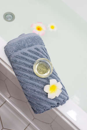 White Sink Gray Towell Candle Plumeria Flower SPA at Home Concept Vertical Top Viewの写真素材