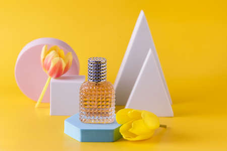 Abstract background for Branding and Minimal Presentation Perfume Bottle on Geometric Podium on Yellow Background Concept Shoppingの写真素材