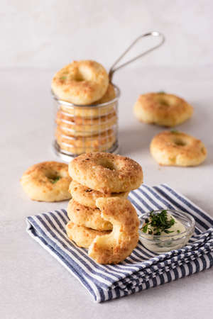 Stack of Homemade and Tasty Cheese Donuts with Spices on Napkin Verticalの写真素材