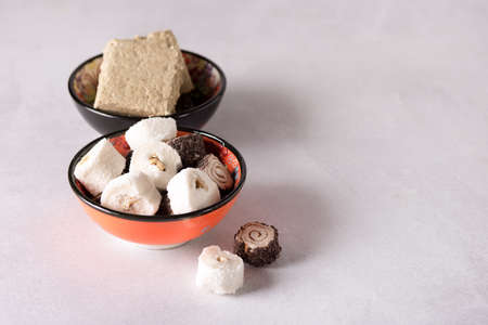 Tasty Turkish Delight on Colored Bowls Gray Background Horizontal Copy Space Lokum and Halvaの写真素材