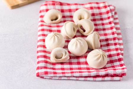Traditional Russian Handmade Dumplings Frozen on the Wooden Tray Gray Background Russian Pelmeni Ravioli Horizontalの写真素材