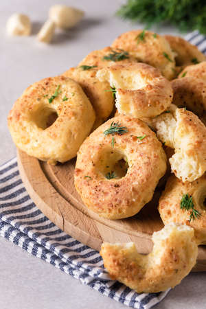 Homemade Cheese Donuts with Spices on Wooden Tray Gray Background Verticalの写真素材