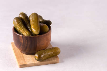 Wooden bowl of Homemade organic salted cucumbers Organic healthy food Gray backgroundmarinated Place...