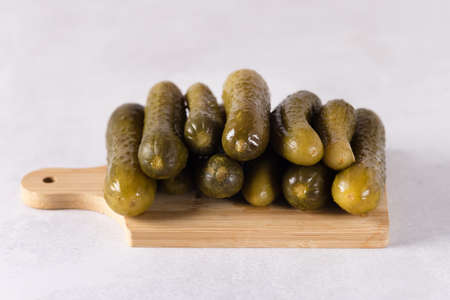 Group of Salted Pickles Cucumber on a wooden cutting board On a gray backgroundの写真素材