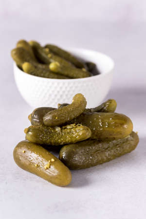 Small pickled cucumbers on gray background Verticalの写真素材