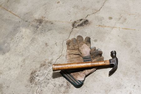Hammer and Gloves on Concrete